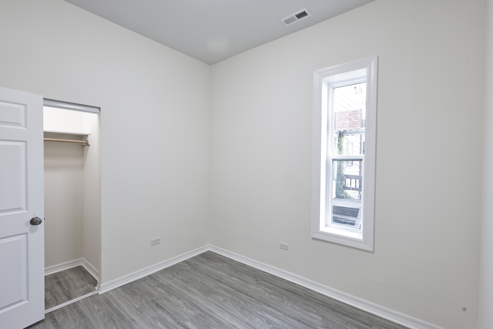 3621 South Winchester Avenue, Unit 1 Chicago, IL 60609 - Photo 16 of 24 an empty room with wooden floor and windows