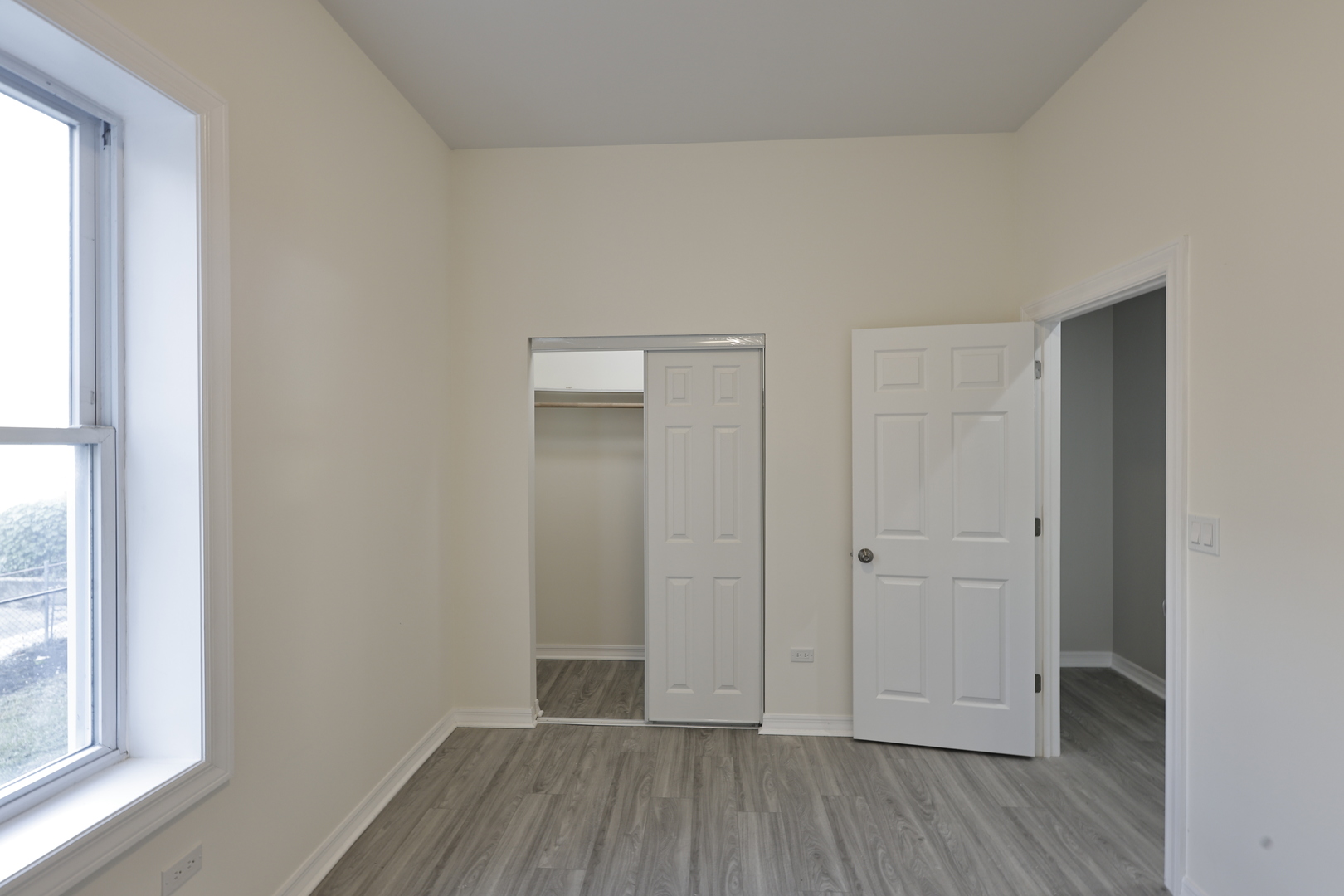 3621 South Winchester Avenue, Unit 1 Chicago, IL 60609 - Photo 19 of 24 an empty room with wooden floor and windows