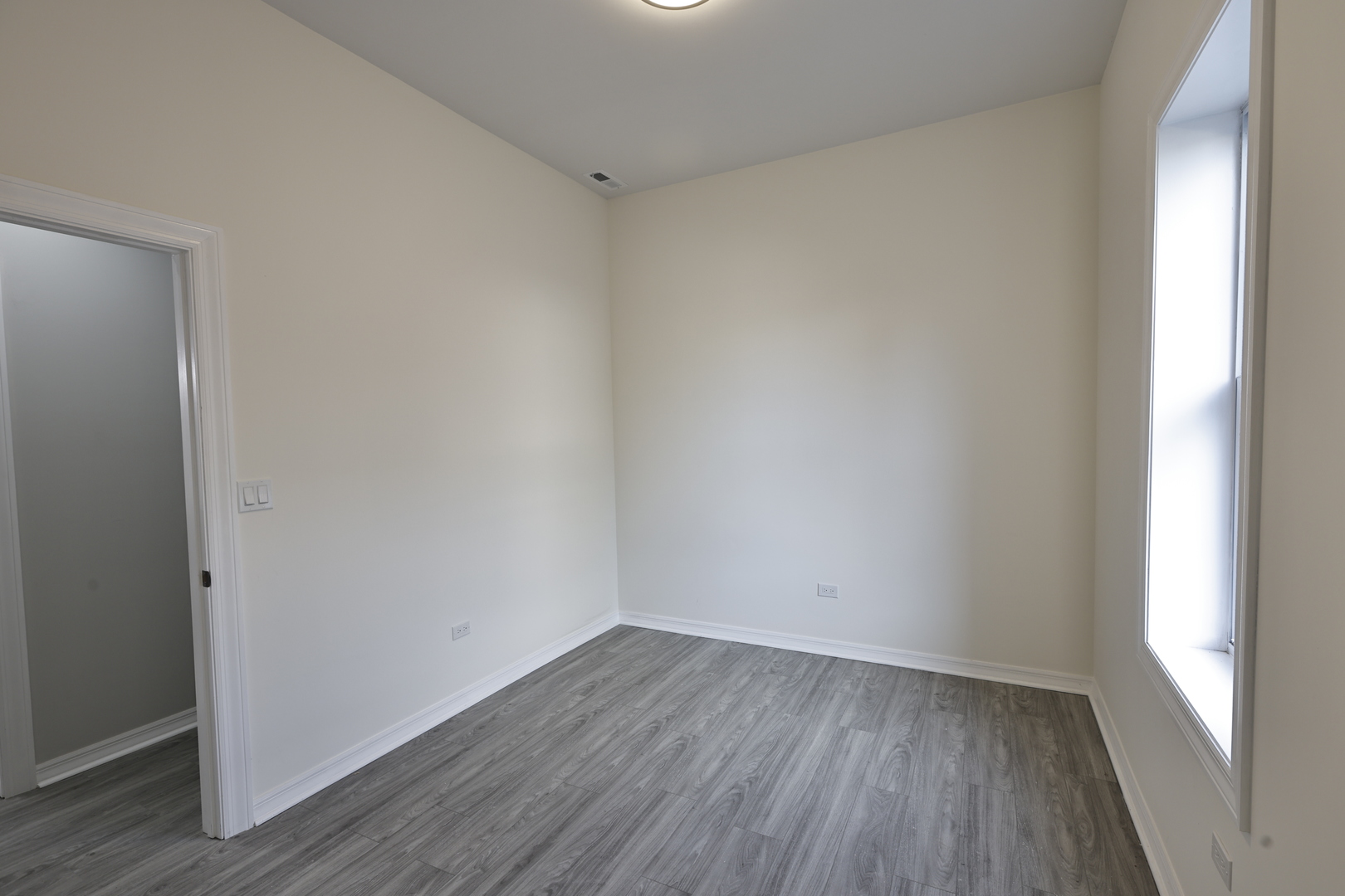 3621 South Winchester Avenue, Unit 1 Chicago, IL 60609 - Photo 20 of 24 a view of a small space with wooden floor and a window