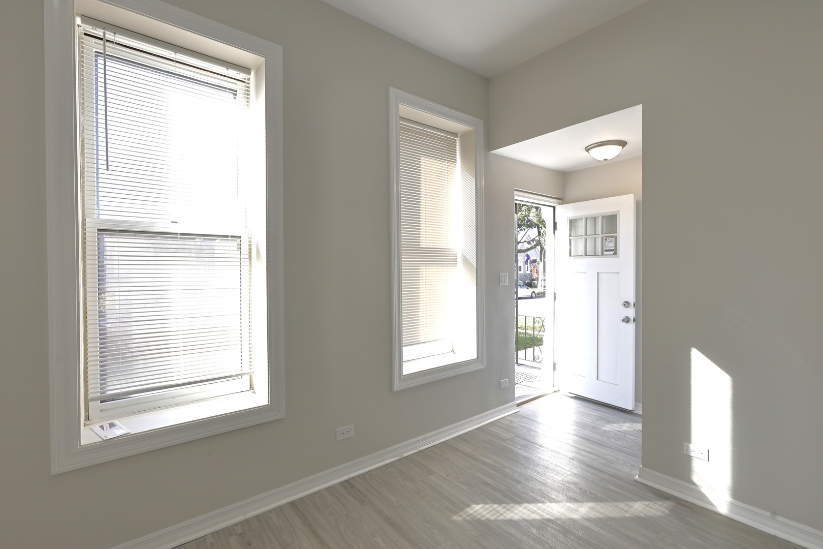 3621 South Winchester Avenue, Unit 1 Chicago, IL 60609 - Photo 8 of 24 a view of an empty room with wooden floor and a window