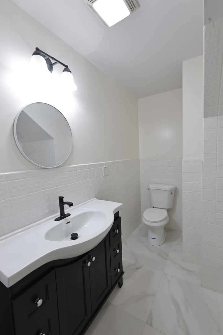 3621 South Winchester Avenue, Unit 1 Chicago, IL 60609 - Photo 9 of 24 a bathroom with a sink and a mirror