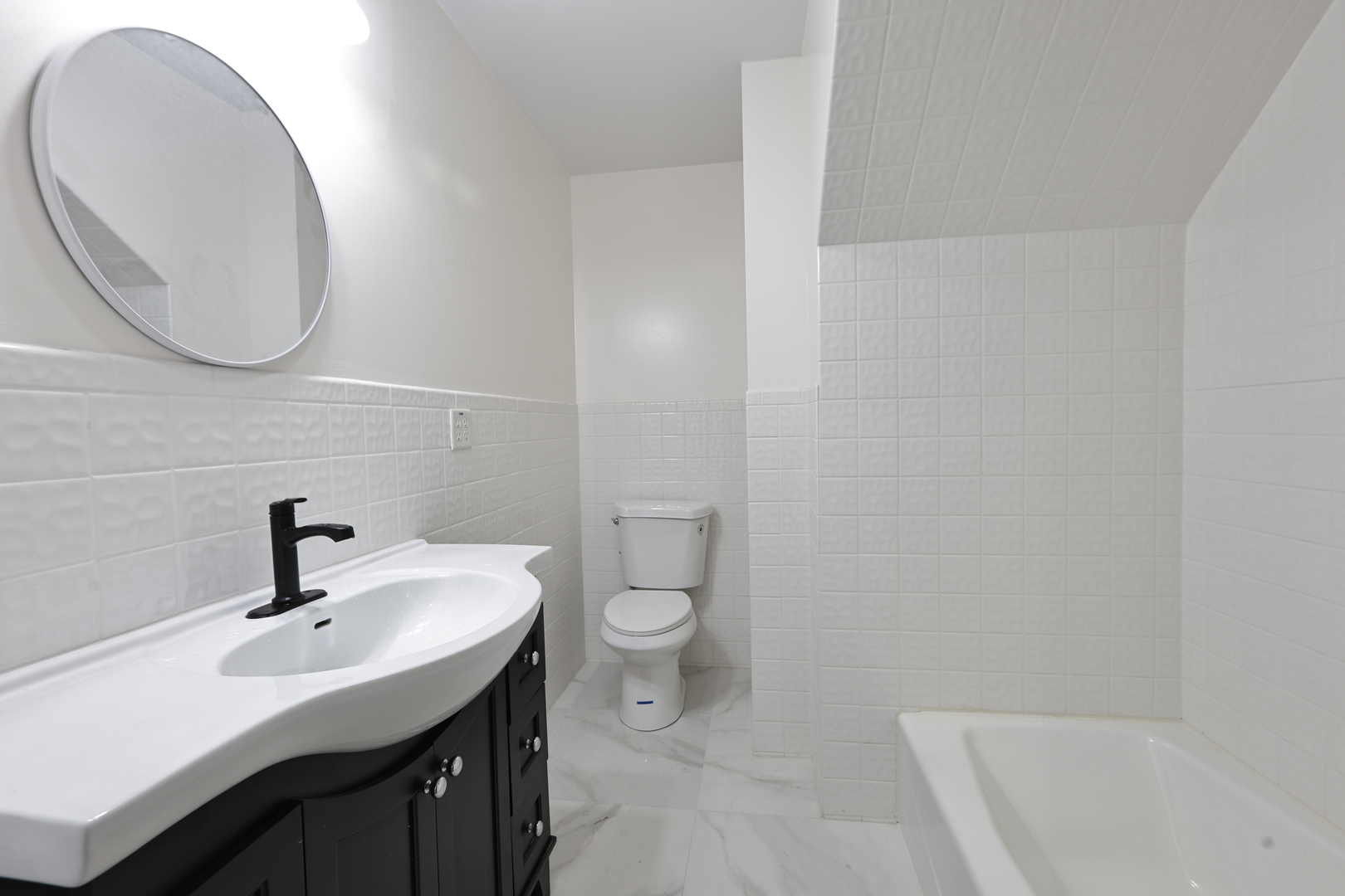 3621 South Winchester Avenue, Unit 1 Chicago, IL 60609 - Photo 10 of 24 a bathroom with a sink a toilet and a mirror