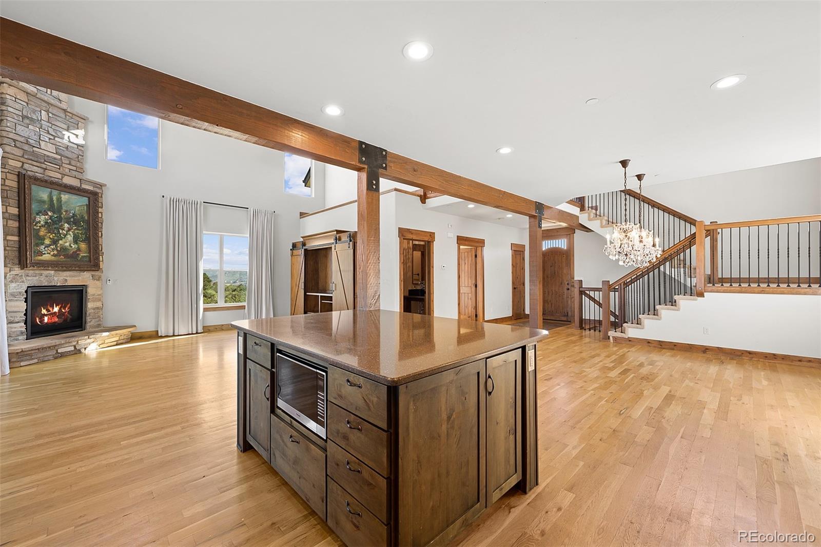 2135 Haystack Road Castle Rock, CO 80104 - Photo 11 of 35 a very nice looking room with wooden floor and a fireplace