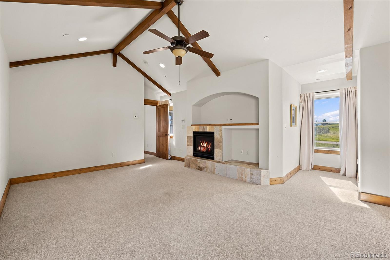2135 Haystack Road Castle Rock, CO 80104 - Photo 16 of 35 an empty room with windows and fireplace