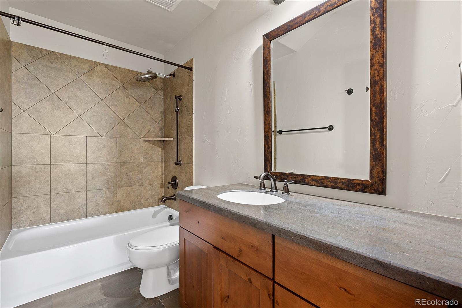 2135 Haystack Road Castle Rock, CO 80104 - Photo 24 of 35 a bathroom with a sink mirror toilet and bathtub