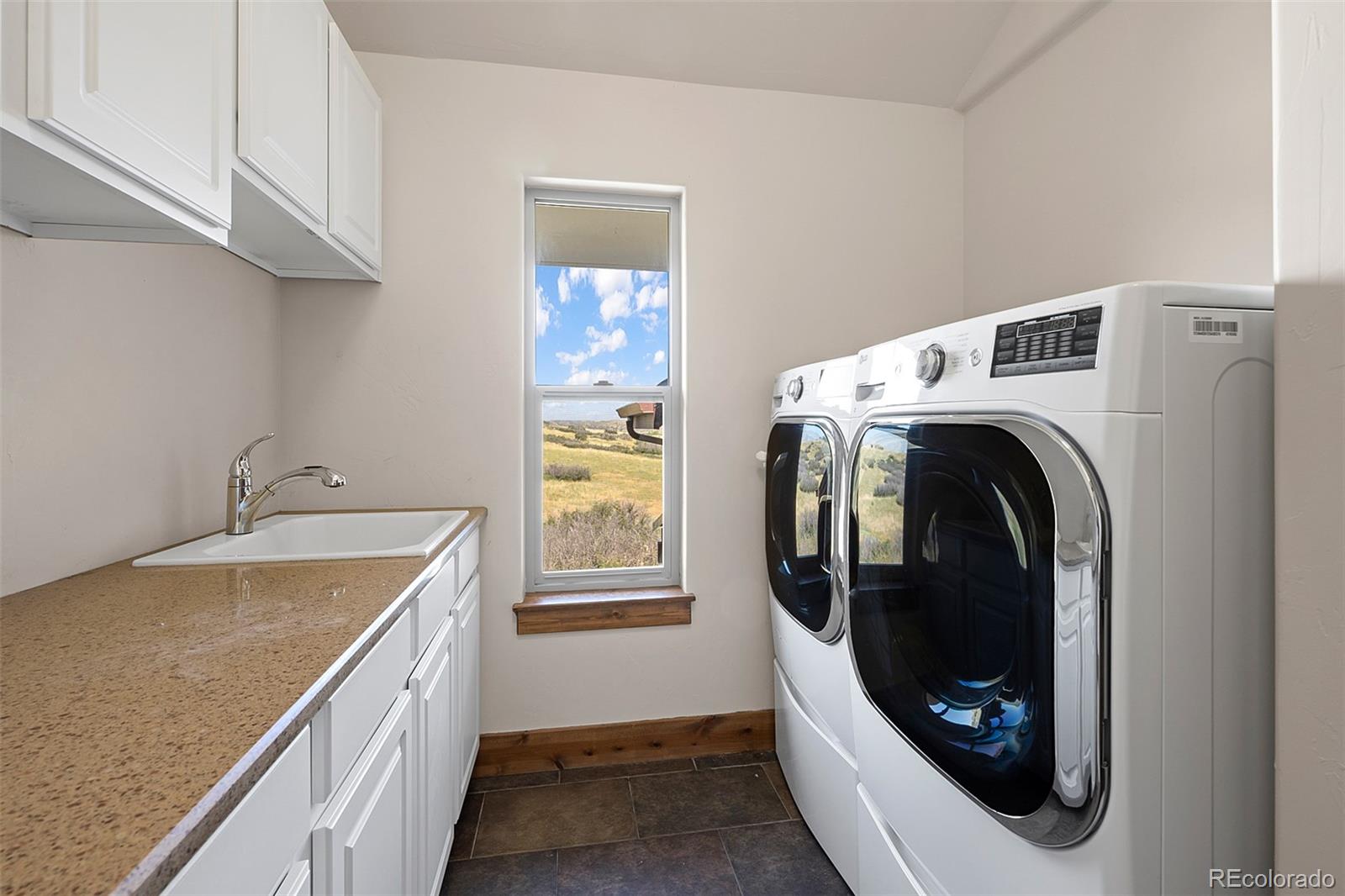 2135 Haystack Road Castle Rock, CO 80104 - Photo 25 of 35 a utility room with dryer and washer