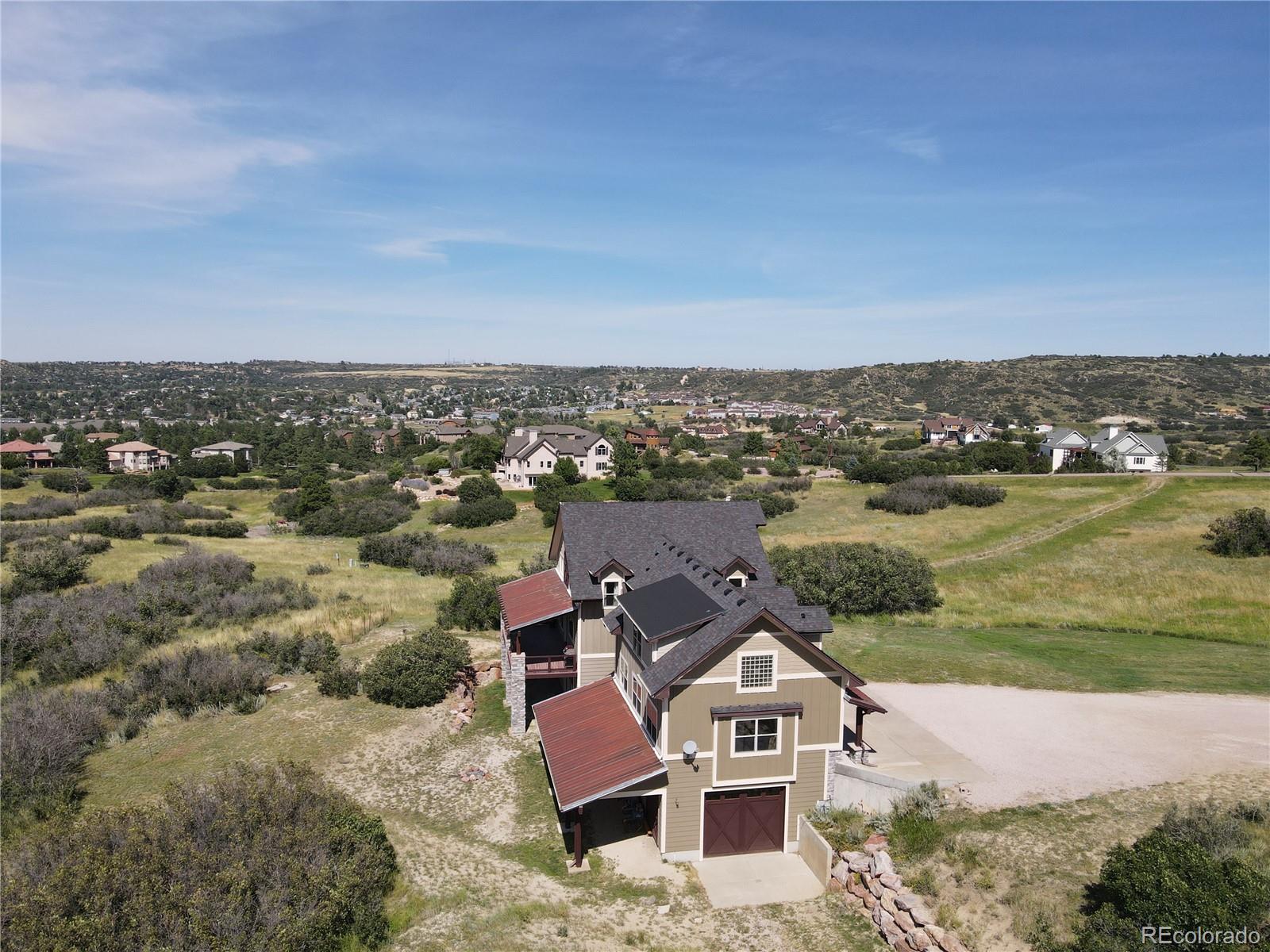 2135 Haystack Road Castle Rock, CO 80104 - Photo 32 of 35 an aerial view of a house with a lake view