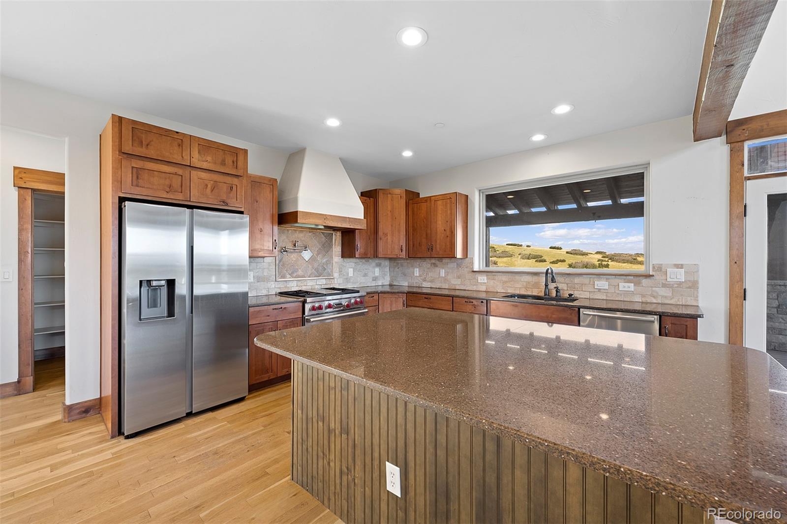 2135 Haystack Road Castle Rock, CO 80104 - Photo 9 of 35 a kitchen with stainless steel appliances granite countertop a refrigerator a sink and a stove