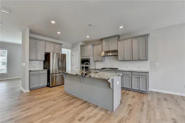 a kitchen with granite countertop a stove and a sink