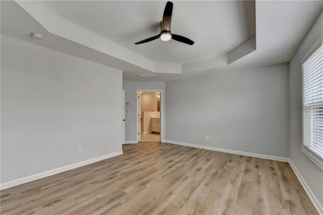 a view of a hallway with wooden floor and closet