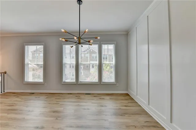a large kitchen with stainless steel appliances granite countertop a stove and a wooden floors