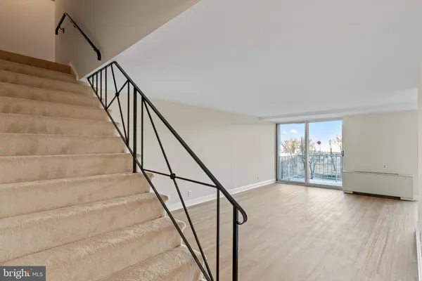 a view of an entryway with wooden floor
