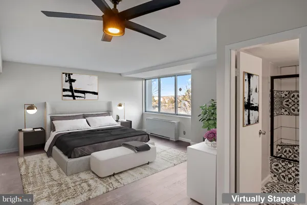 a bedroom with a bed couch and window