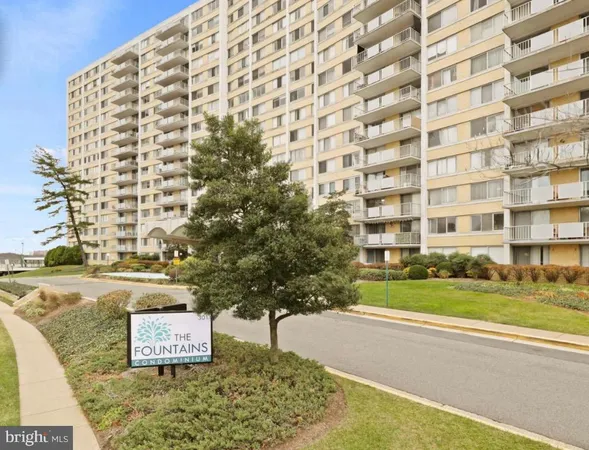 a view of a tall building next to a yard