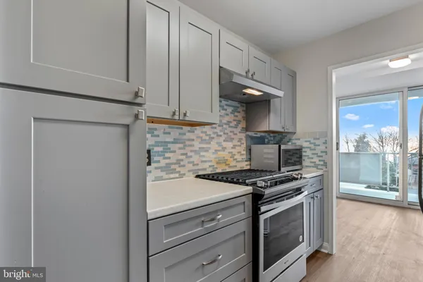 a kitchen with stainless steel appliances a stove and a microwave