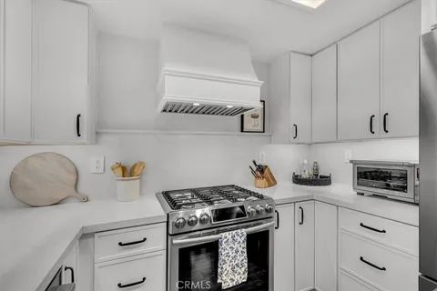 a kitchen with granite countertop a stove and a sink