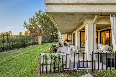 a view of a house with backyard and porch