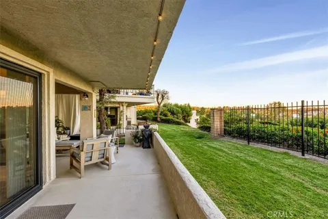 a view of a patio with chairs and a table