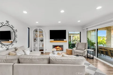 a living room with fireplace furniture and a flat screen tv
