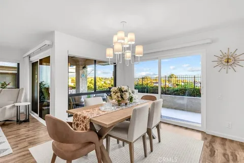 a view of a dining room with furniture wooden floor and chandelier