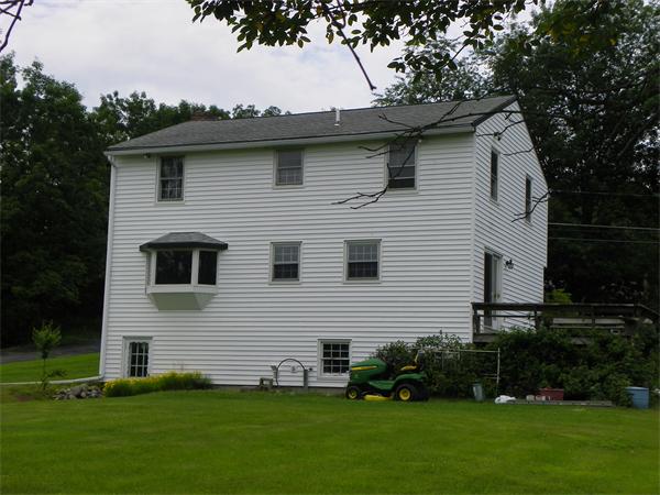 91 Nashua Road Pepperell, MA 01463 - Photo 3 of 14 a front view of a house with a garden