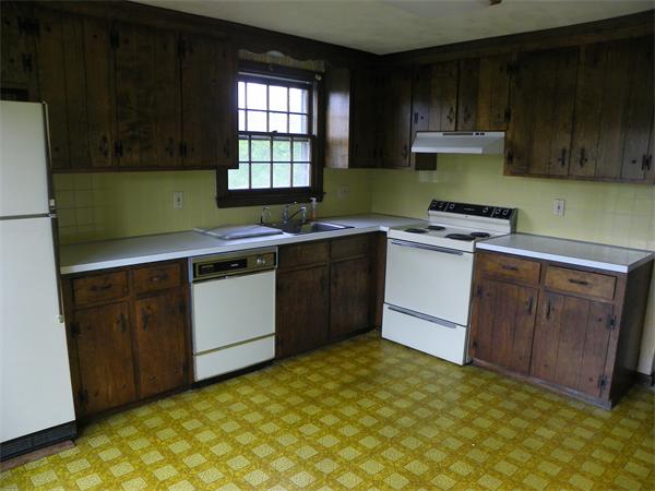91 Nashua Road Pepperell, MA 01463 - Photo 4 of 14 a kitchen with a sink stove and cabinets