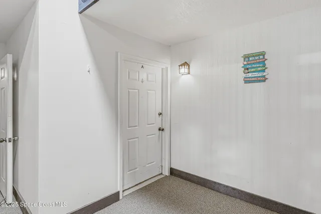 a view of empty room with ceiling fan