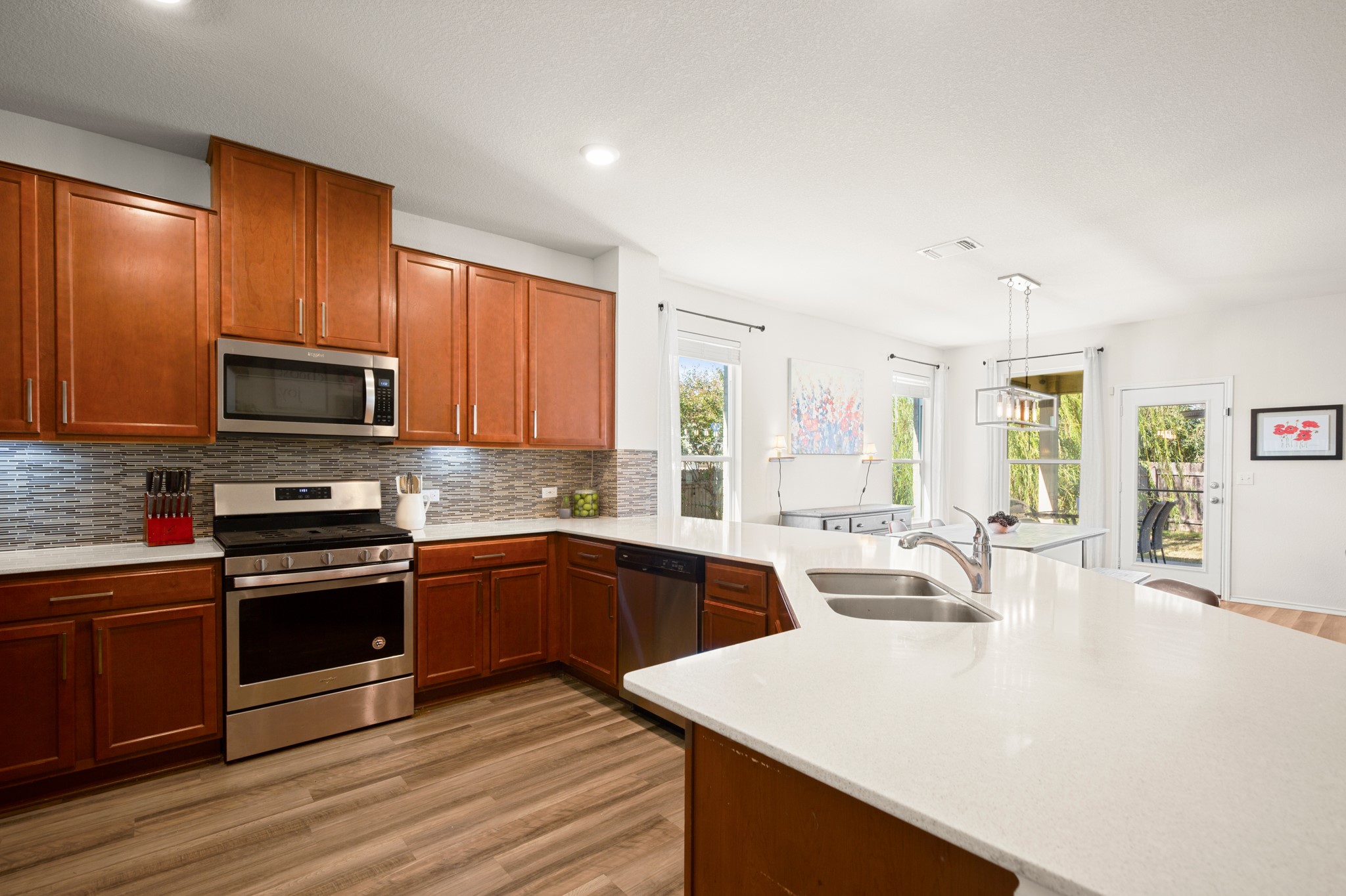 101 Kavanaugh Street Georgetown, TX 78628 - Photo 12 of 32 a large kitchen with stainless steel appliances and wooden cabinets