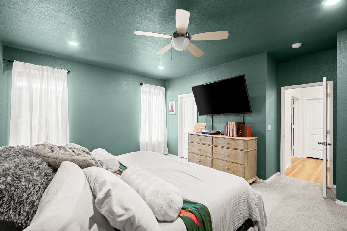 101 Kavanaugh Street Georgetown, TX 78628 - Photo 18 of 32 a bedroom with a large bed and a flat screen tv
