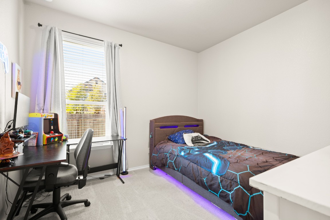 101 Kavanaugh Street Georgetown, TX 78628 - Photo 21 of 32 a bedroom with a bed and a desk