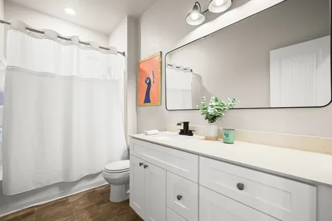 a bathroom with a sink a toilet and a mirror