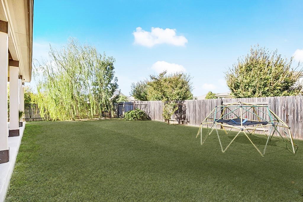 101 Kavanaugh Street Georgetown, TX 78628 - Photo 26 of 32 a view of a backyard with table and chairs and potted plants