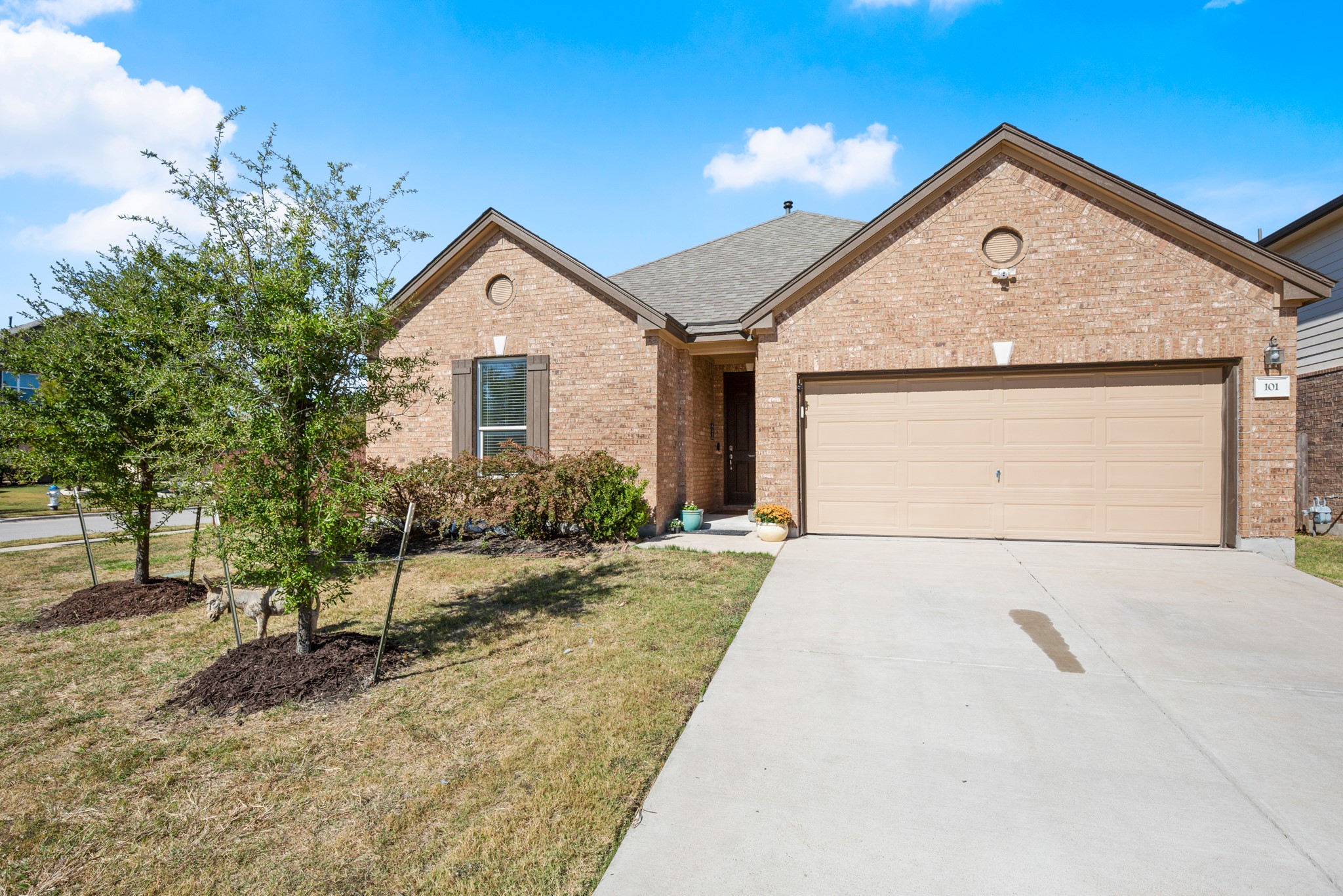 101 Kavanaugh Street Georgetown, TX 78628 - Photo 30 of 32 a front view of a house with a yard and garage