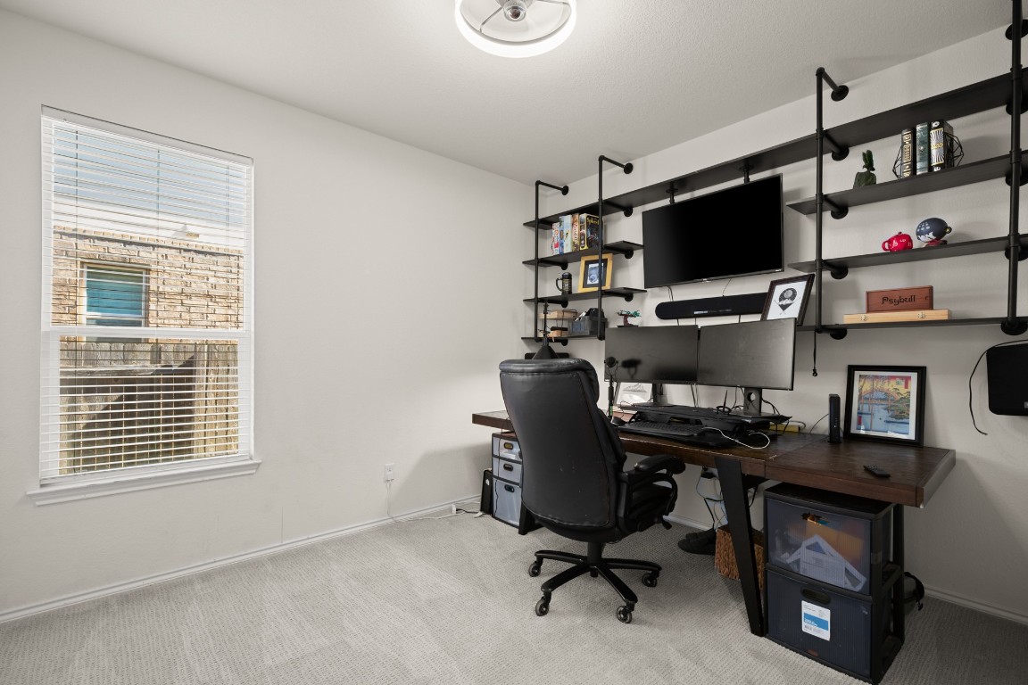 101 Kavanaugh Street Georgetown, TX 78628 - Photo 6 of 32 a view of a workspace with furniture and a window
