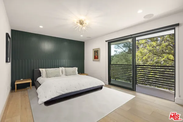 a bedroom with a large bed and a large window
