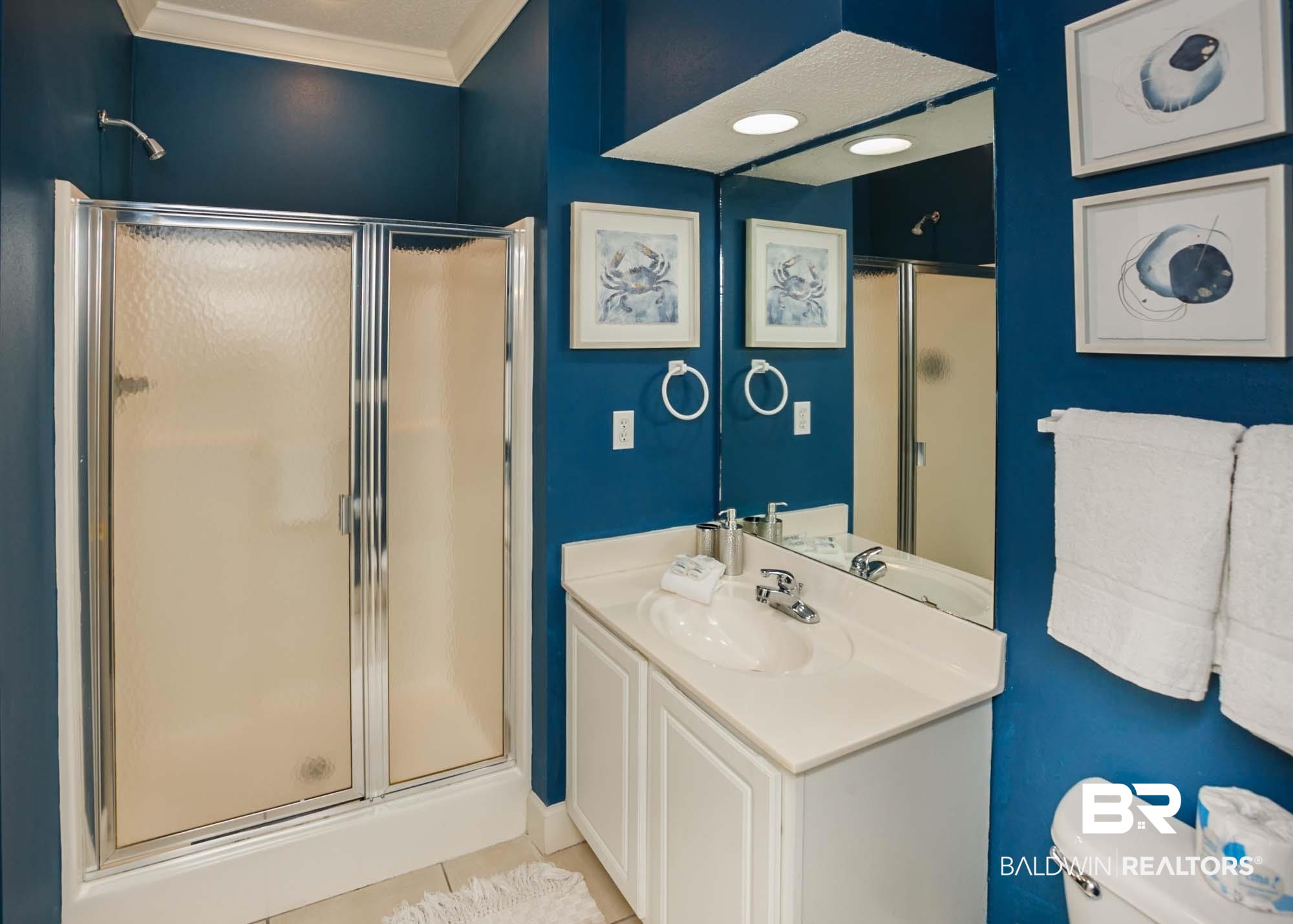 28910 Perdido Beach Boulevard, Unit 4B Orange Beach, AL 36561 - Photo 31 of 48 Bathroom with tile patterned floors, toilet, vanity, a shower stall, and ornamental molding