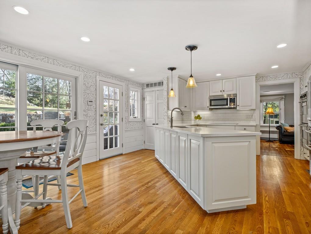 119 Hampshire Road Wellesley, MA 02481 - Photo 3 of 19 a kitchen with stainless steel appliances kitchen island granite countertop a stove a sink a refrigerator and white cabinets with wooden floor