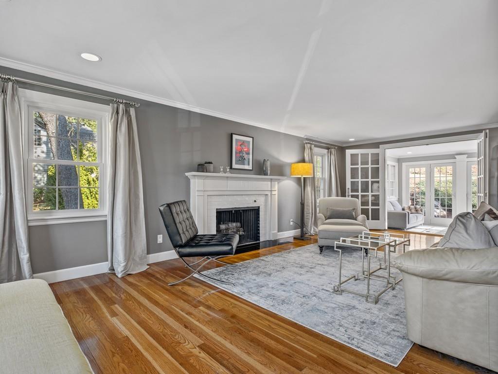 119 Hampshire Road Wellesley, MA 02481 - Photo 7 of 19 a living room with furniture a large window and a fireplace