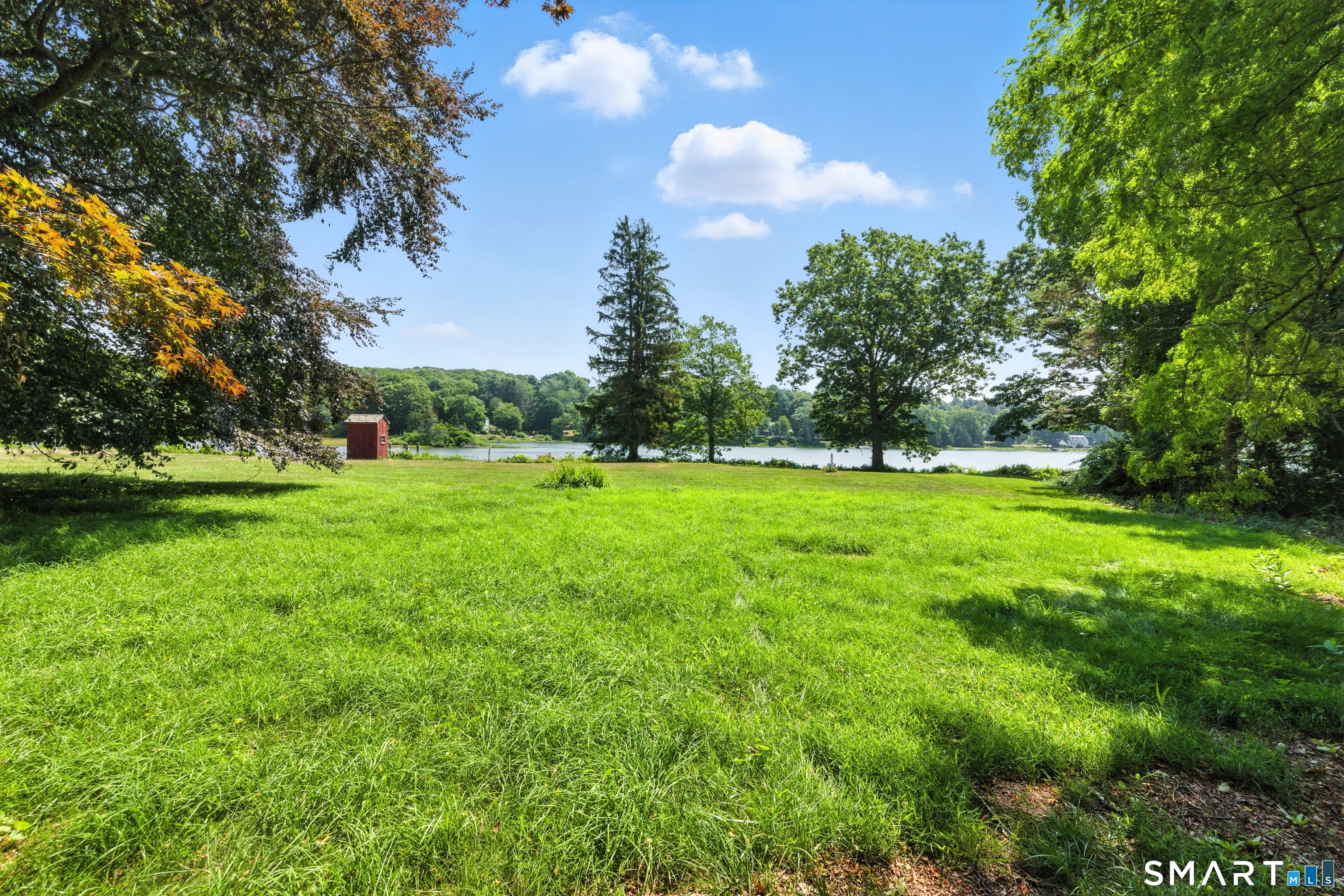 82 Cove Road Stonington, CT 06378 - Photo 11 of 20 a view of a grassy field with trees around