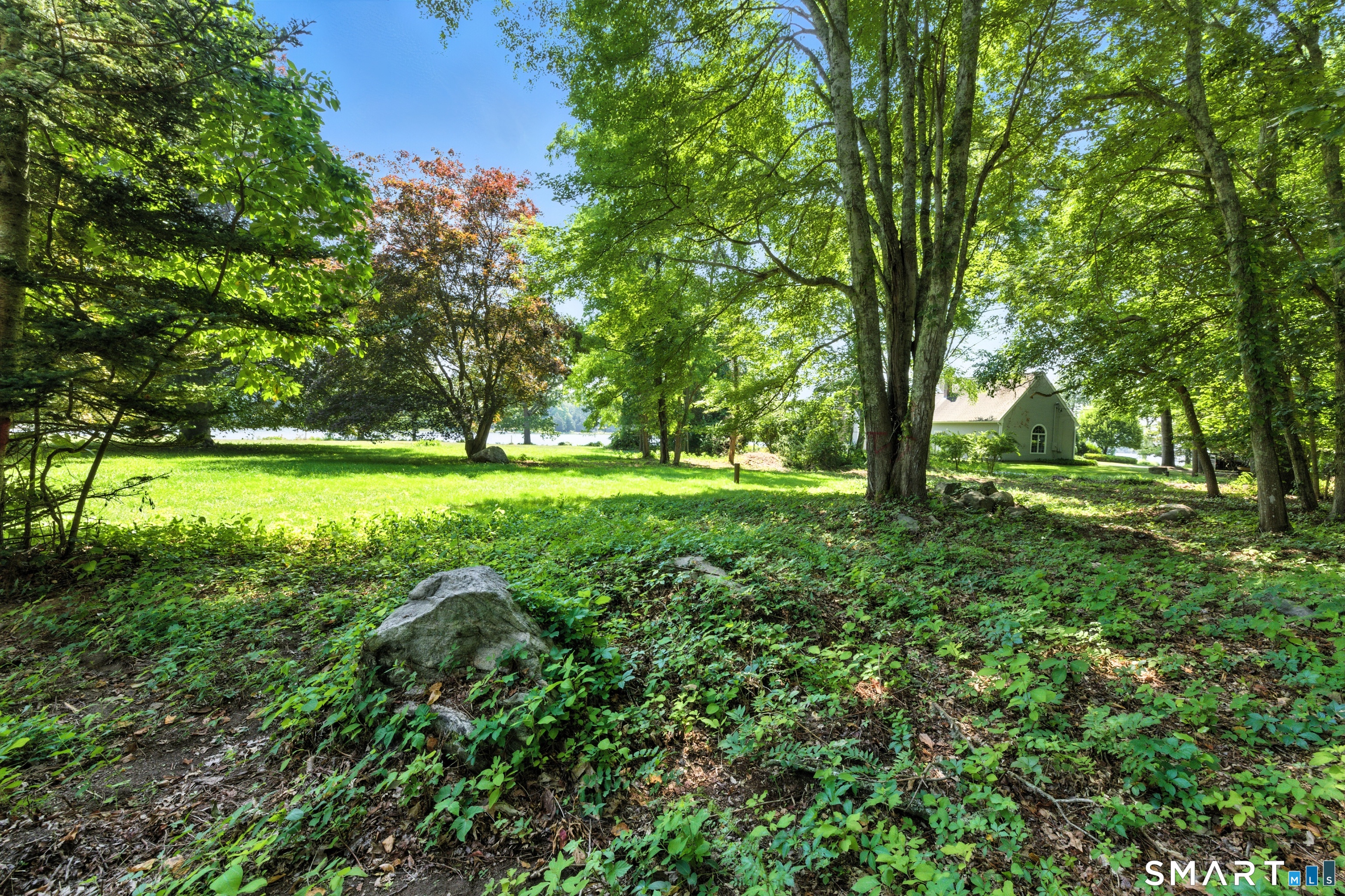 82 Cove Road Stonington, CT 06378 - Photo 16 of 20 a view of outdoor space with deck and yard