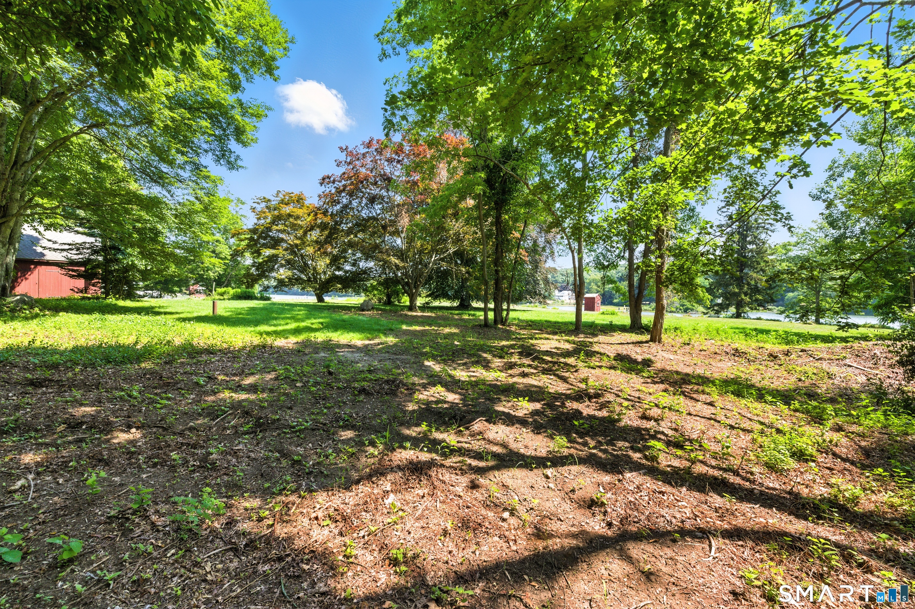 82 Cove Road Stonington, CT 06378 - Photo 18 of 20 a view of a green field with trees