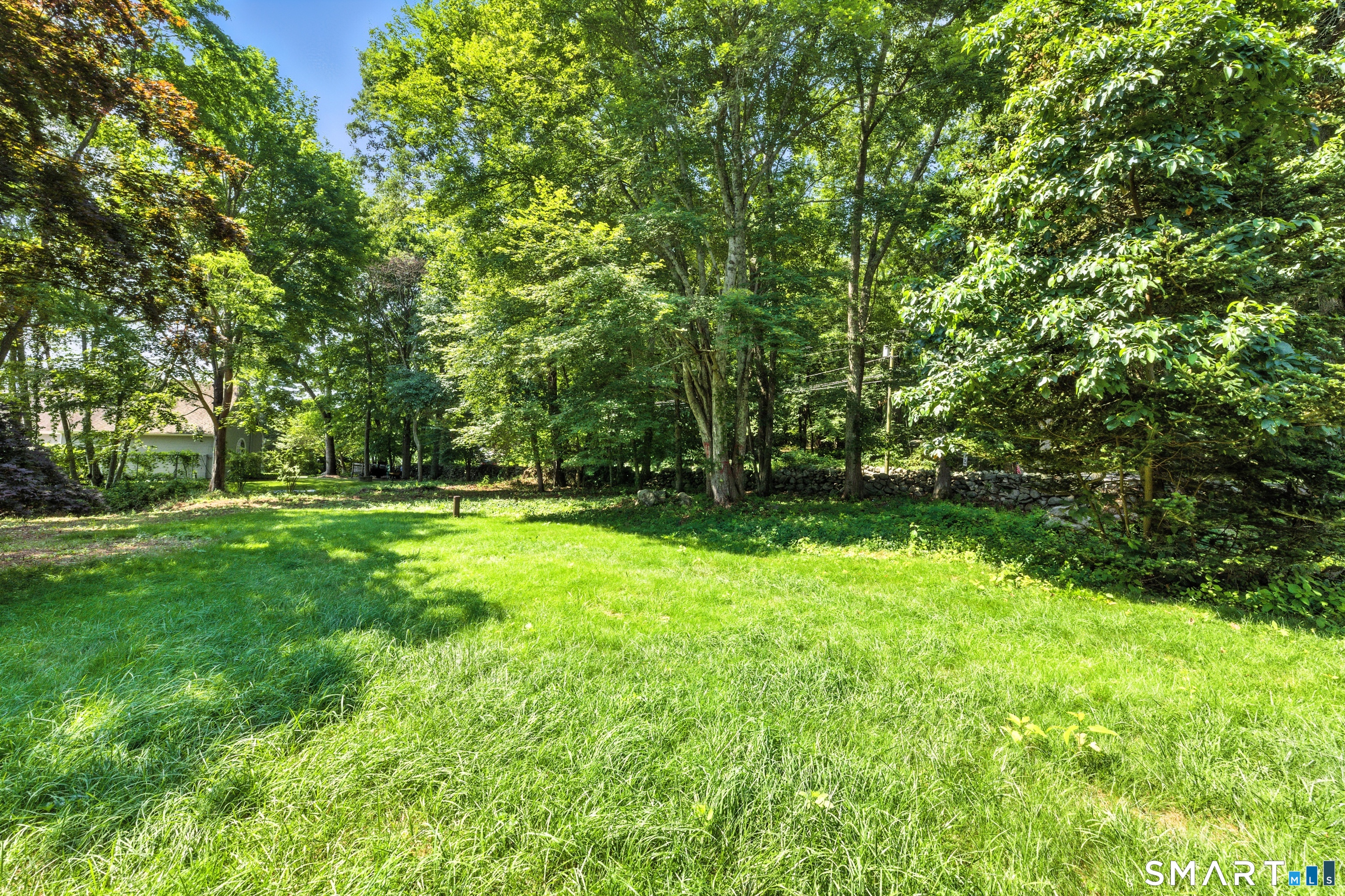 82 Cove Road Stonington, CT 06378 - Photo 20 of 20 a view of outdoor space with deck and yard