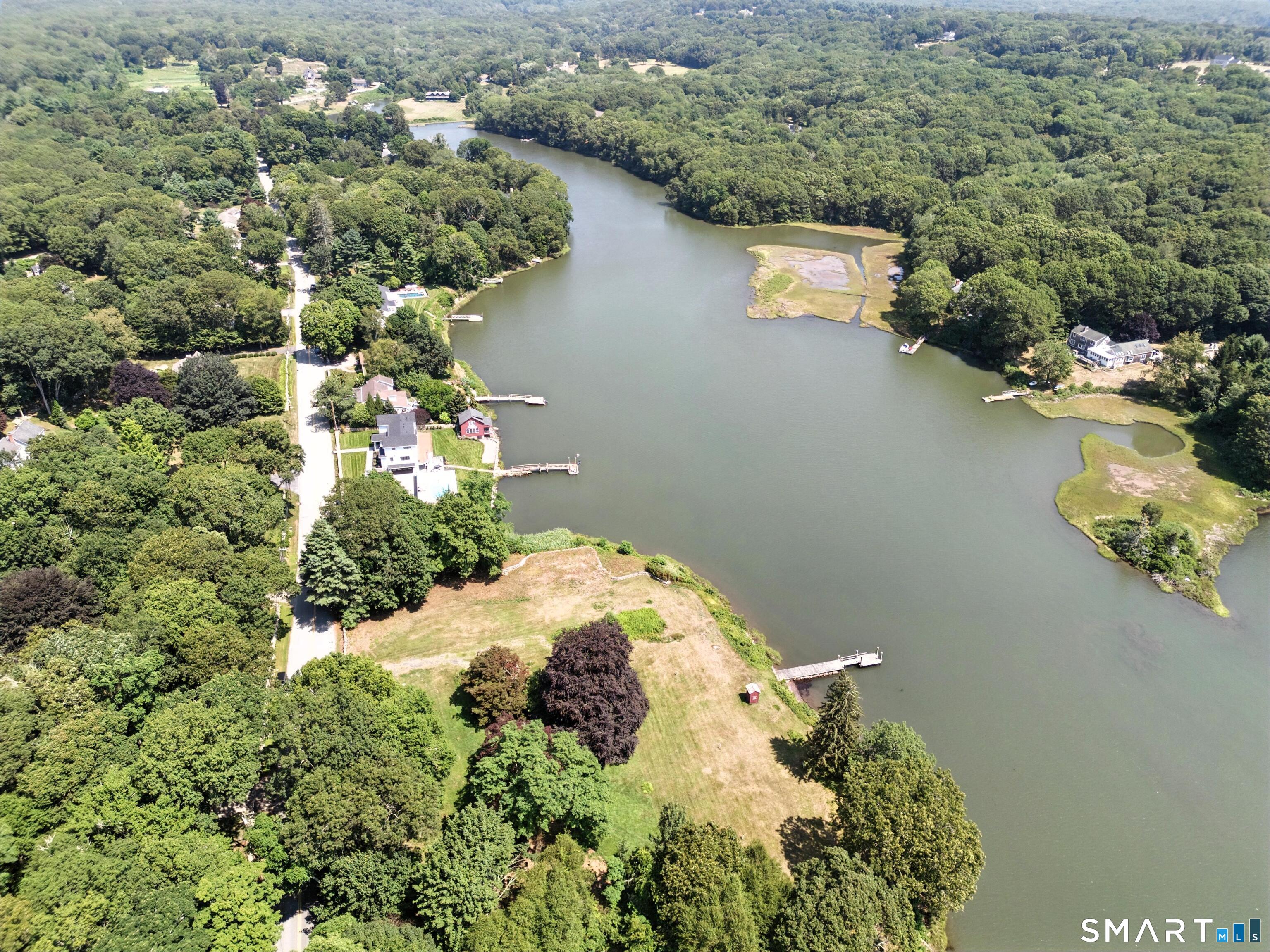 82 Cove Road Stonington, CT 06378 - Photo 8 of 20 an aerial view of a house with a yard and lake view