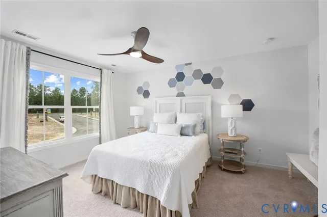 a bedroom with a large bed and a window