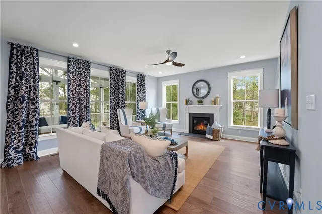 a living room with furniture a fireplace and a large window
