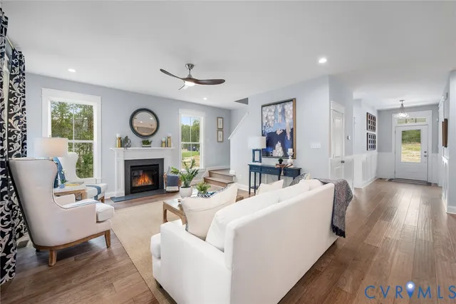 a living room with furniture a clock and a fireplace