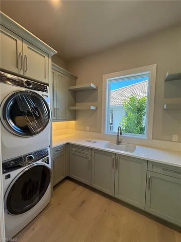 a view of a kitchen with sink washer and dryer