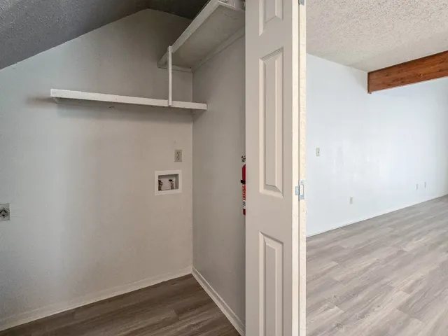 an empty room with a window and a ceiling fan