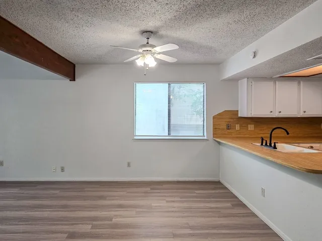 a kitchen with a sink a refrigerator and window