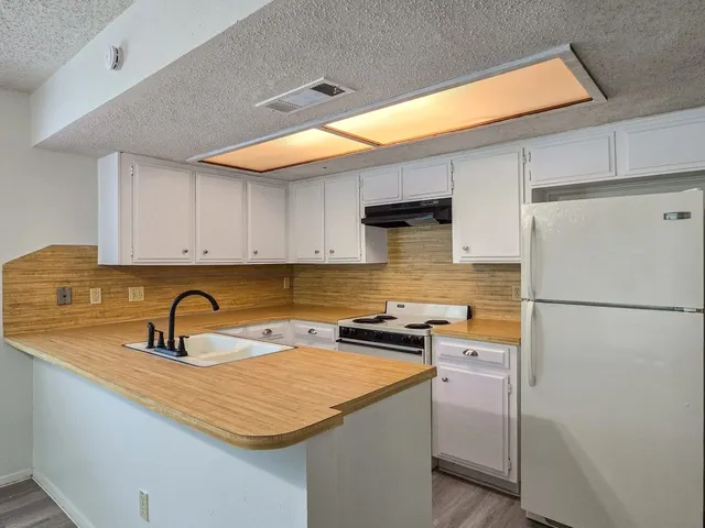 a kitchen that has a sink and a stove